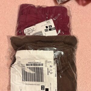 Packaged stretchy pants in Burgundy and Chocolate Brown